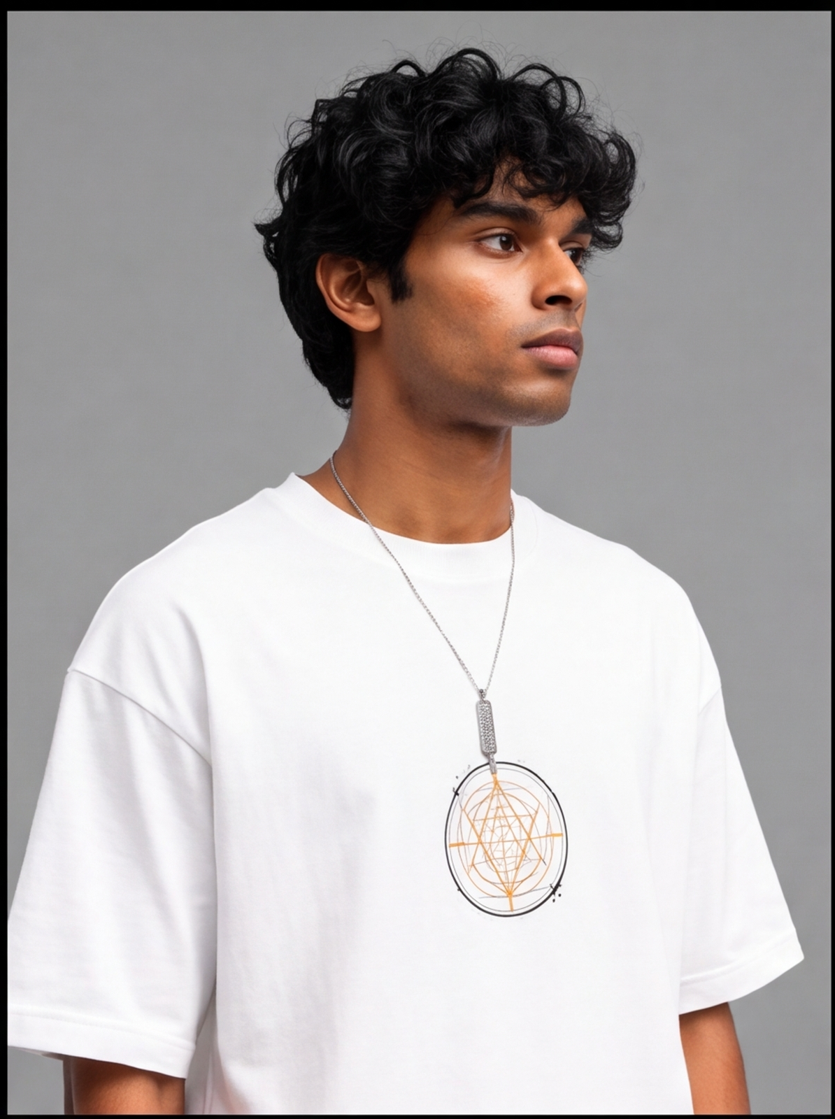 Ouffits white mythic warrior graphic oversized t-shirt — Creator & Destroyer – A man wearing a white oversized t-shirt with a geometric pentagram pendant necklace printed on the chest, set against a plain gray studio background.