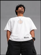 Ouffits white mythic warrior graphic oversized t-shirt — Creator & Destroyer –  A man wearing a white long-sleeve t-shirt with a circular pentagram graphic on the chest and a barcode detail near the hem, paired with black cargo pants, set against a solid gray background.