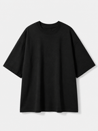 A plain black short-sleeve crewneck t-shirt with a relaxed, oversized fit, displayed against a light gray background.